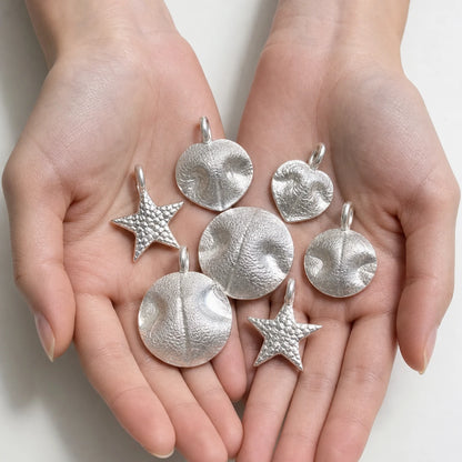 Custom pet nose print silver pendant displayed in hand